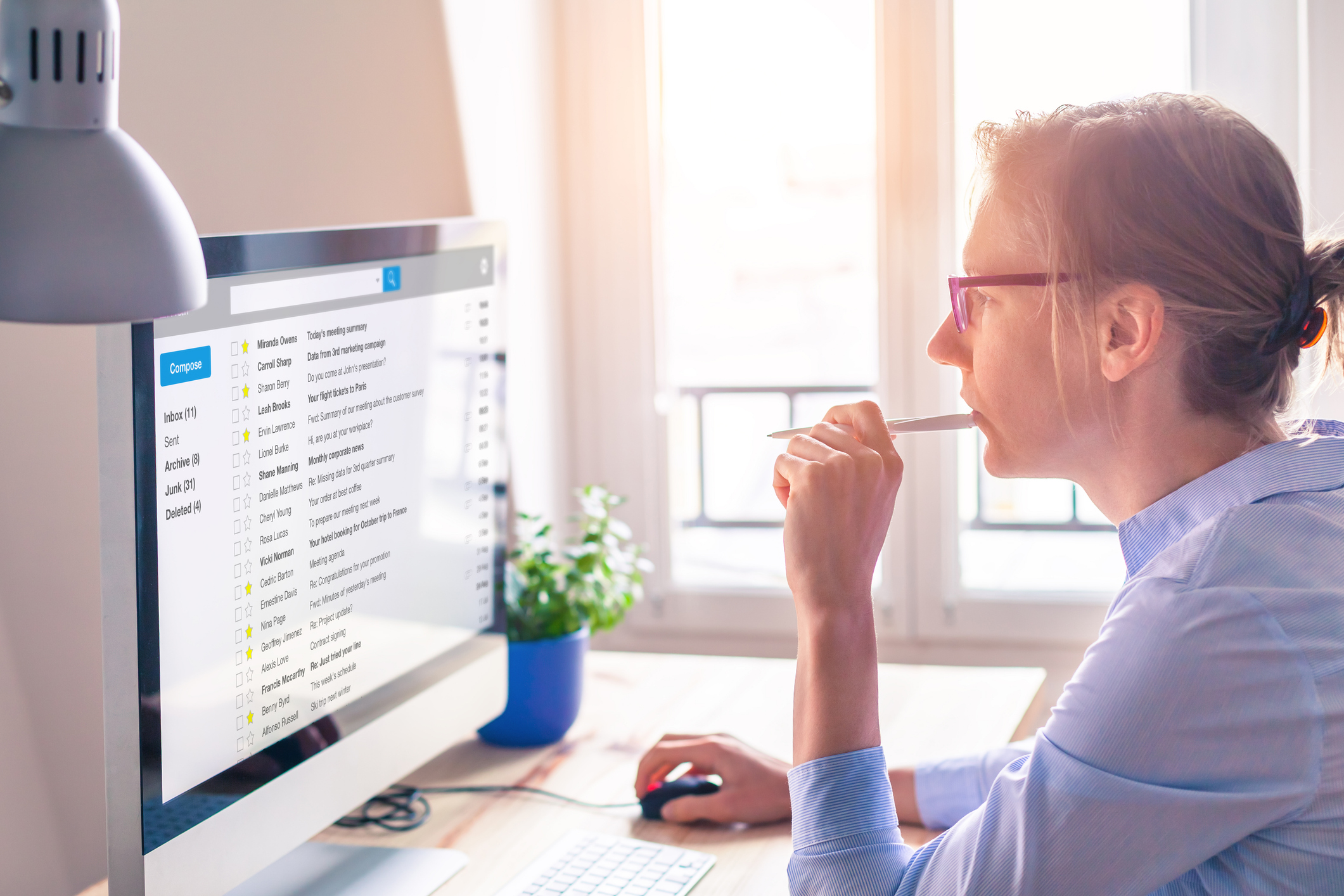 A female business person reads email on computer screen at work for shady-Google-sales-emails blog.