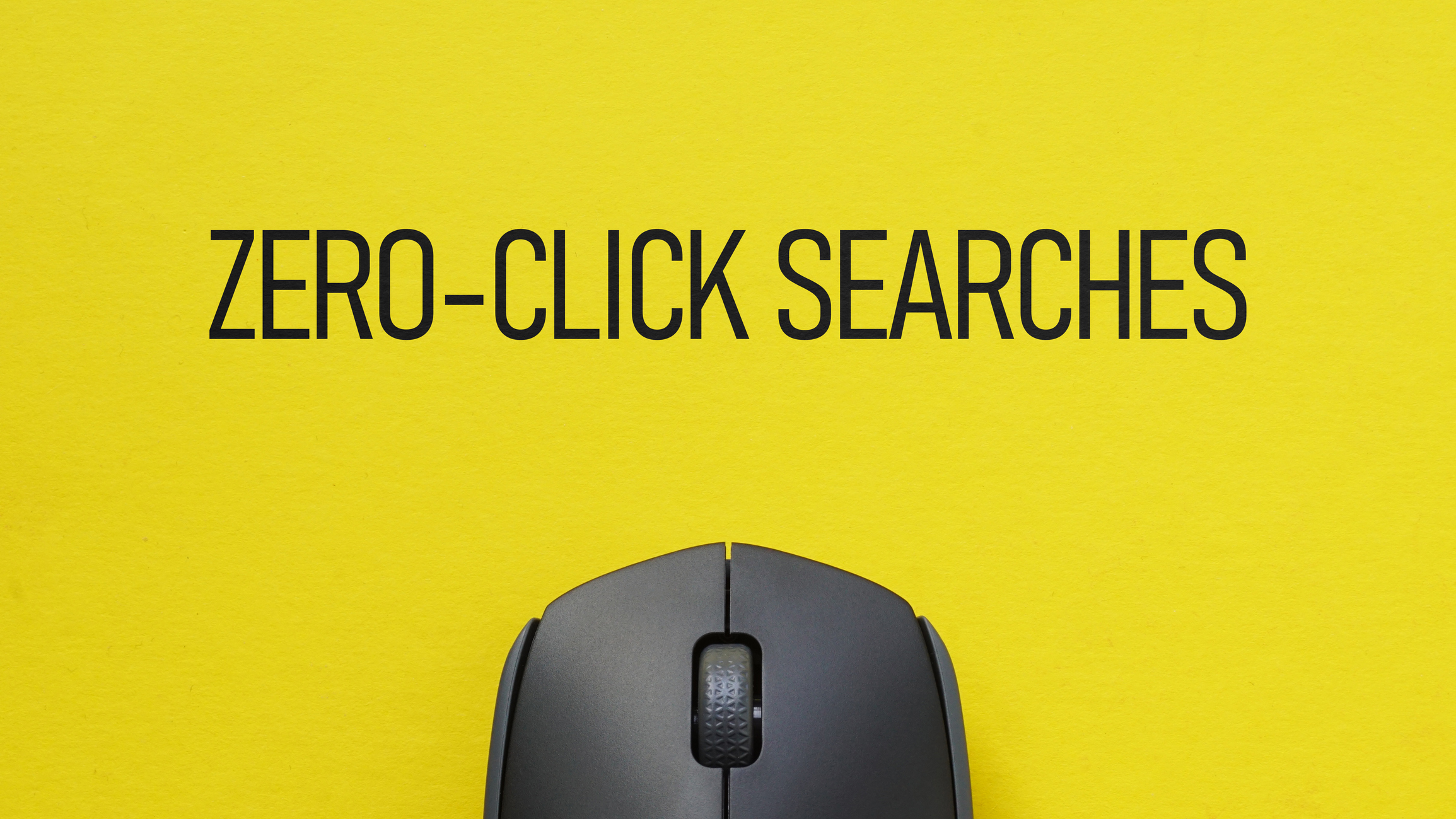 Text "Zero-Click Searches" in plain black font against a yellow background. A black computer mouse rises from the bottom center of the image for zero-click-search blog.