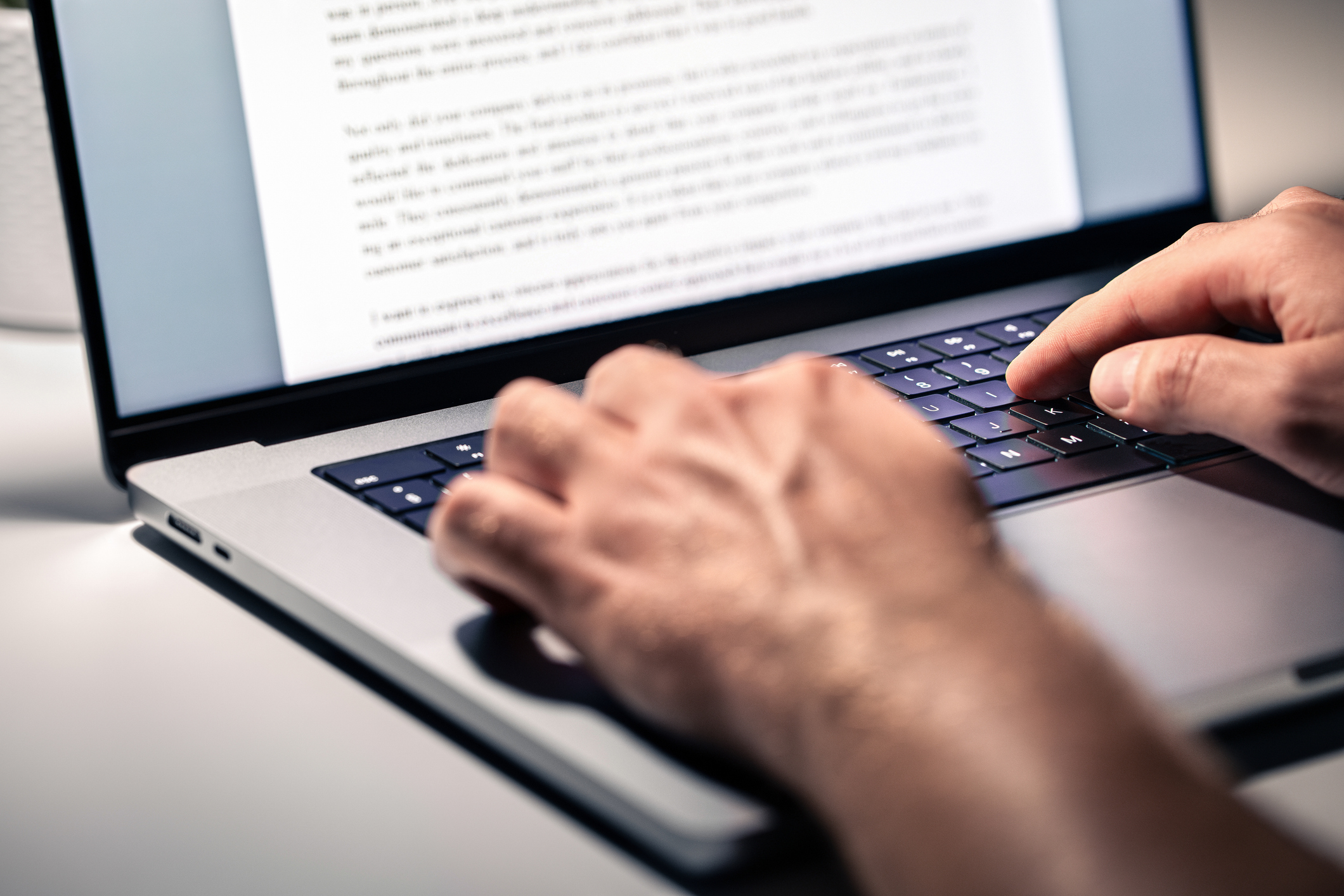 A pair of hands typing on a laptop keyboard for how-to-choose-blog-topics-for-seo blog.